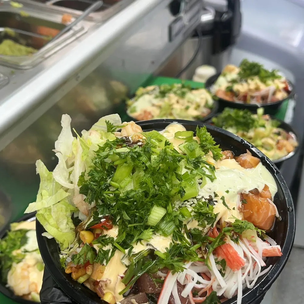A rice bowl with salad and sauce