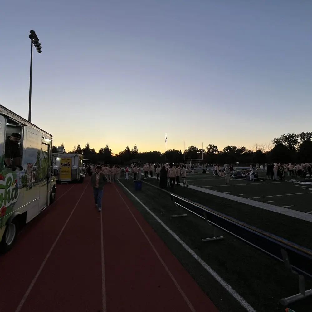 The Aloha truck parked beside an empty running track at sunset