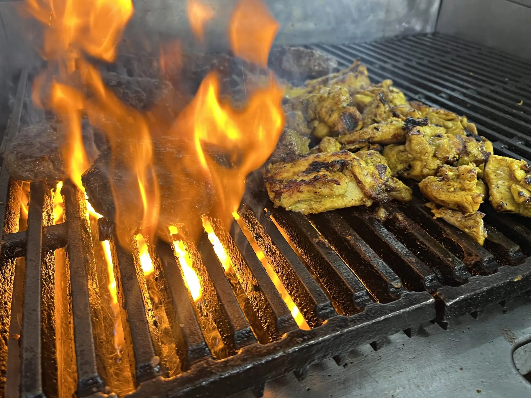 Chicken over open flame on the charcoal grill