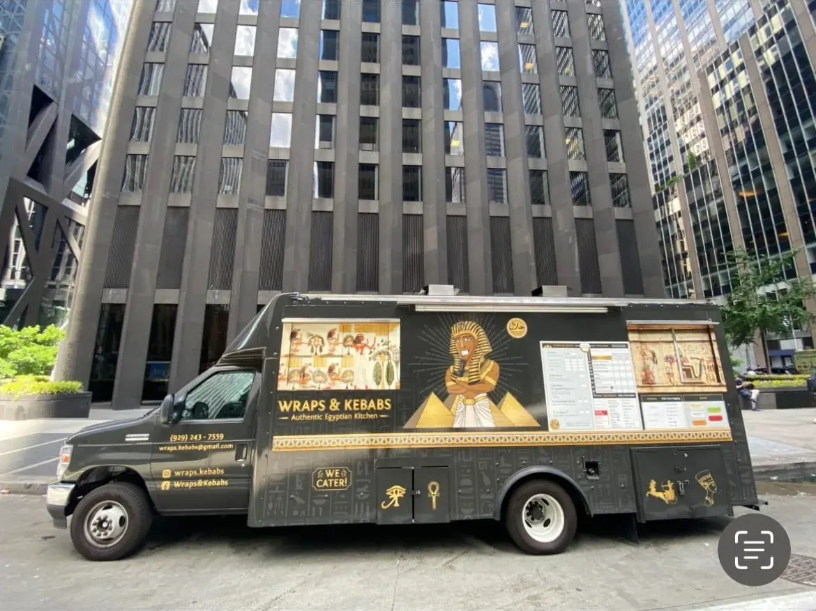 The black and gold Wraps & Kebabs truck parked in Midtown Manhattan
